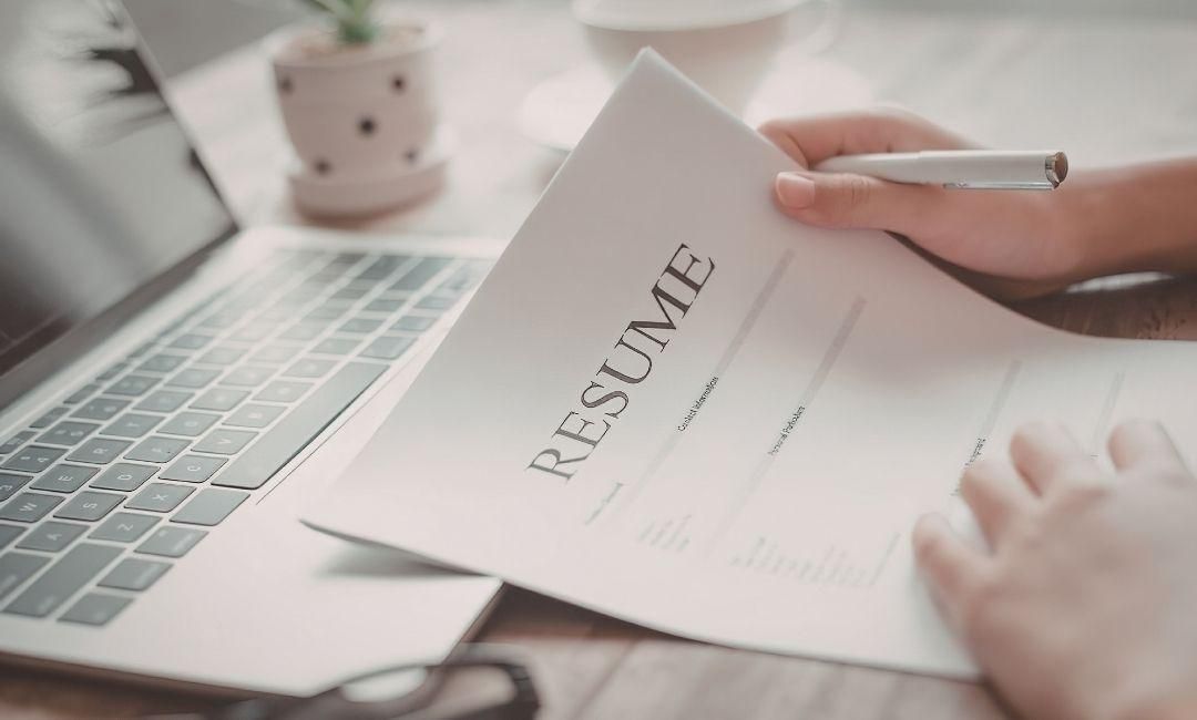 Hand-holding-resume-with-pen