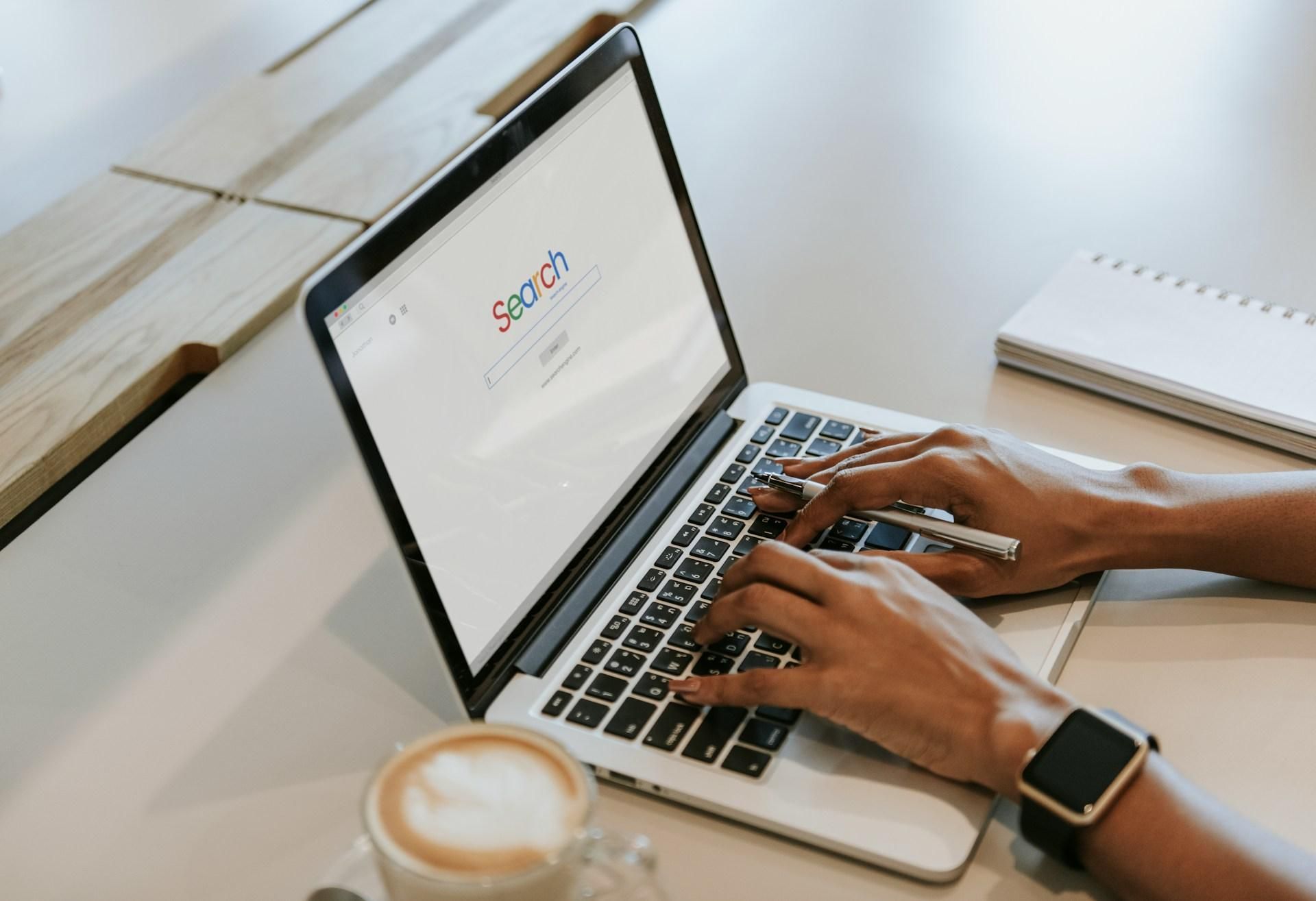 Hands typing on a laptop open to a search engine, researching how to get an internship with no prior experience