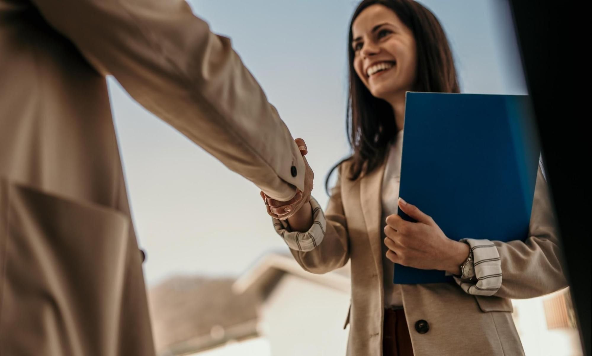 Smiling woman shaking hands after hiring