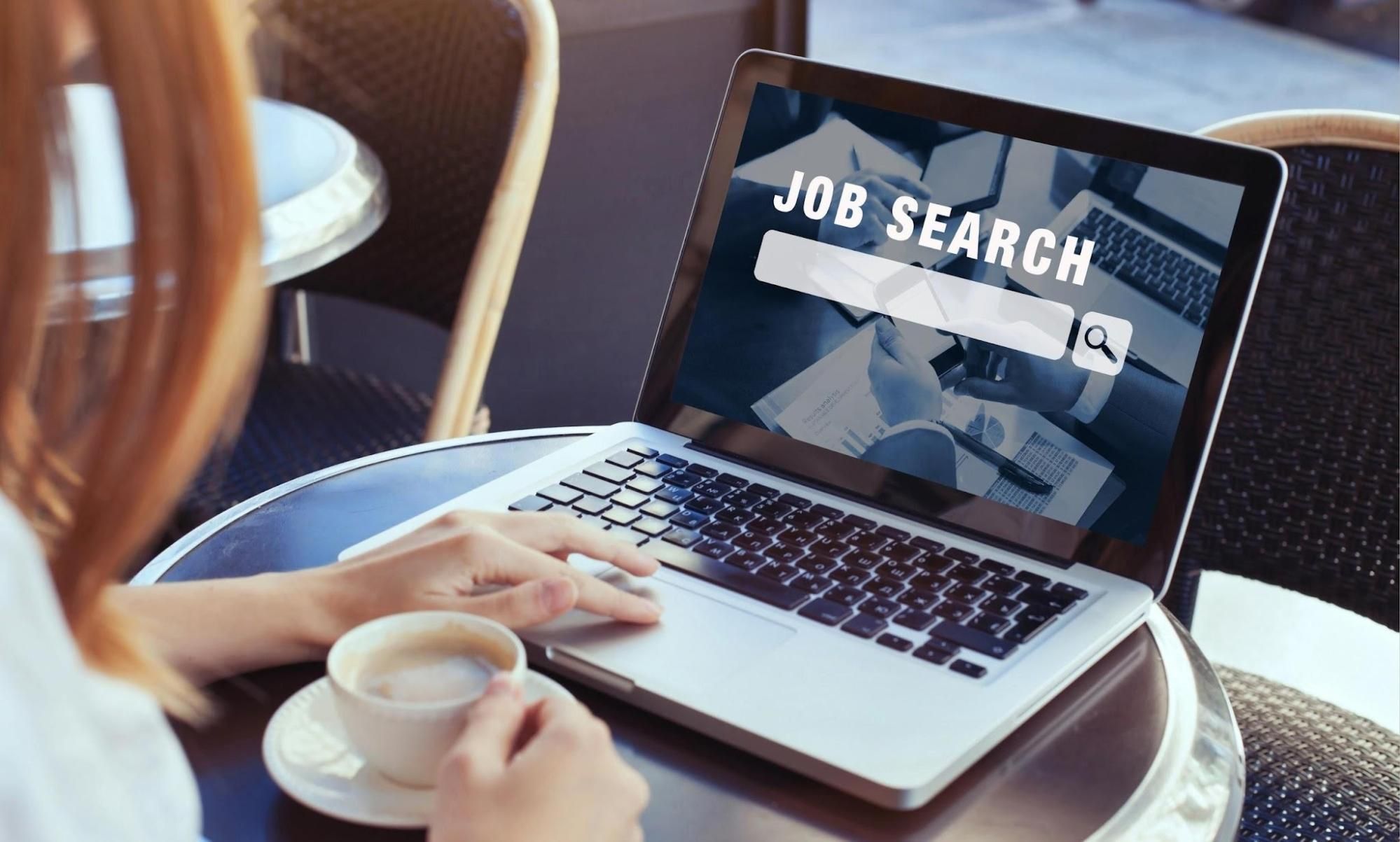 Woman searching jobs with coffee