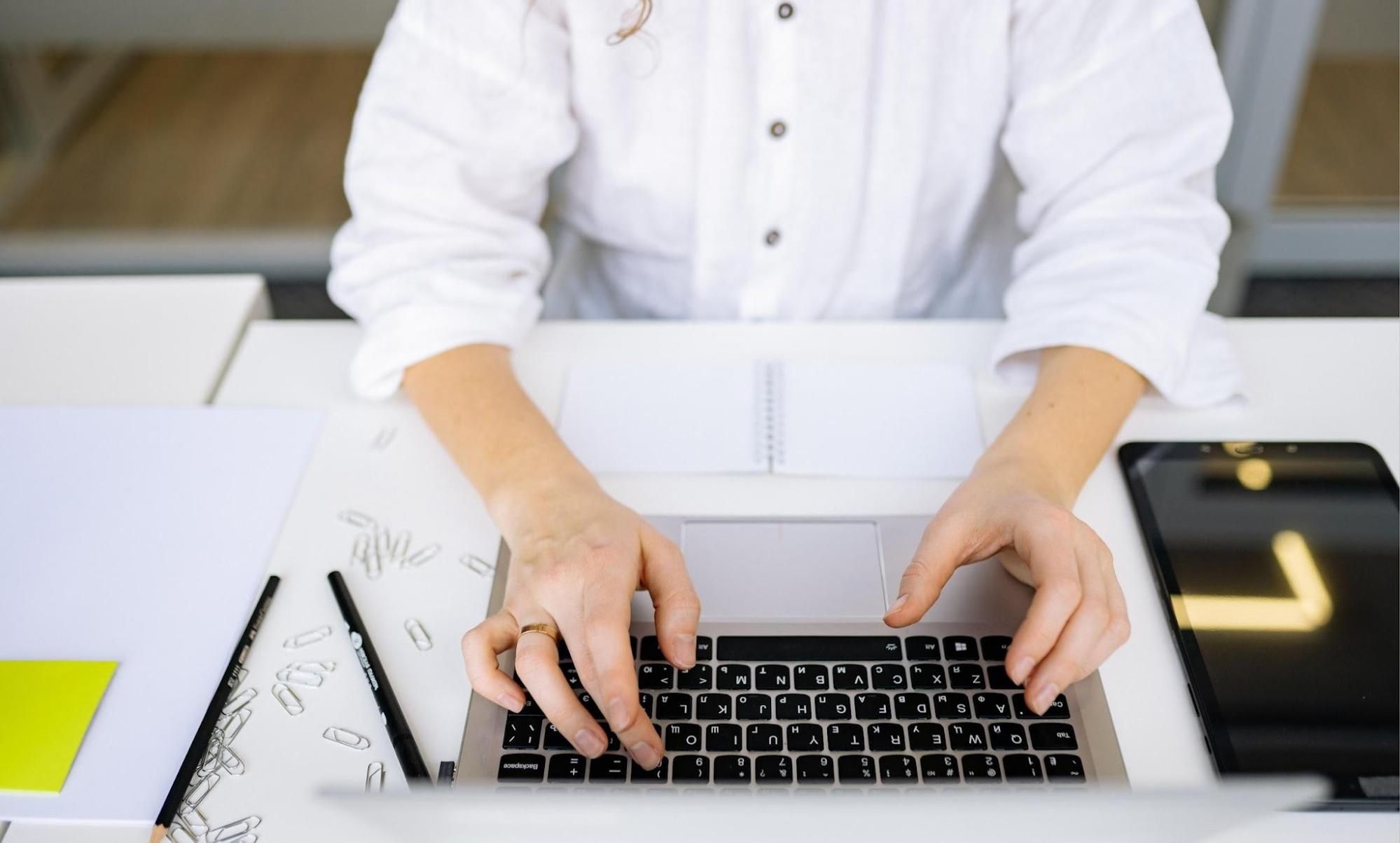 Woman-typing-job-application-on-laptop